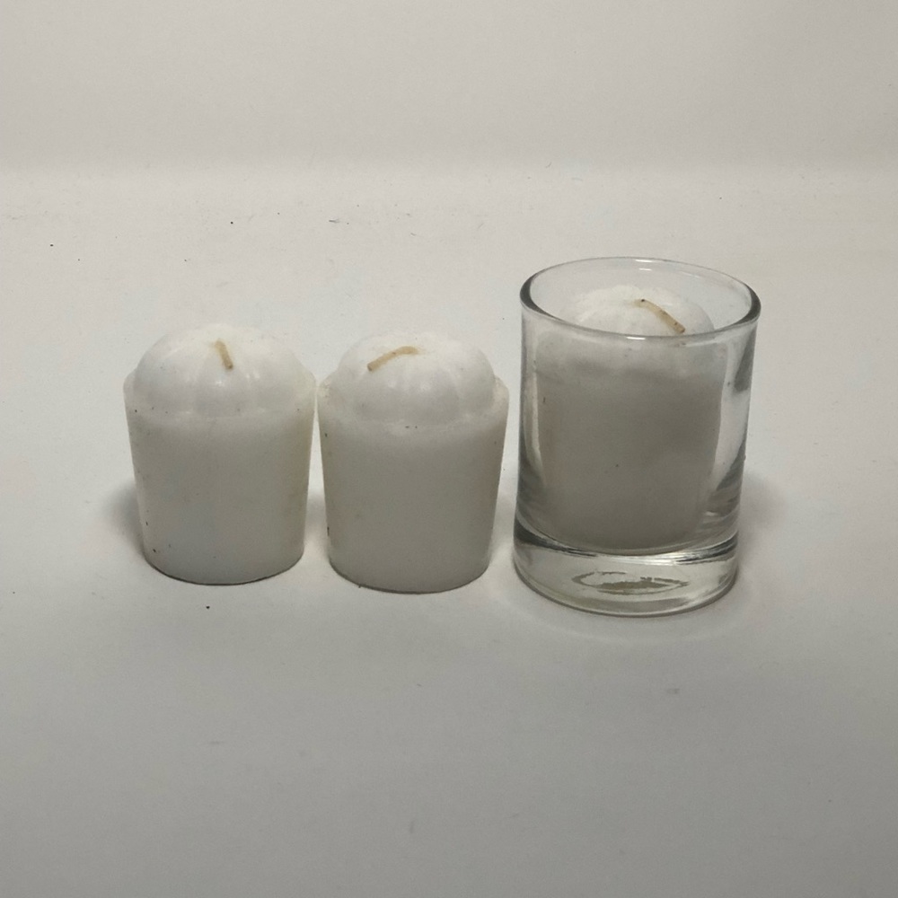 Three White Candles and one Candleholder